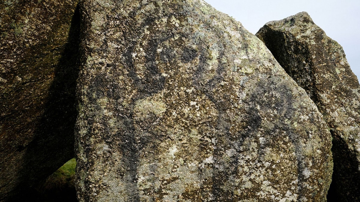 The figures were daubed on one of the granite stones which is part of the Neolithic Mulfra Quoit - that are more than 5,000 years old. The graffiti has caused outrage among the local community and groups that work to protect and preserve the monuments.The stones were believed to have been deliberately targetted due its difficulty to reach up a steep hill in West Cornwall. (Credit: SWNS)