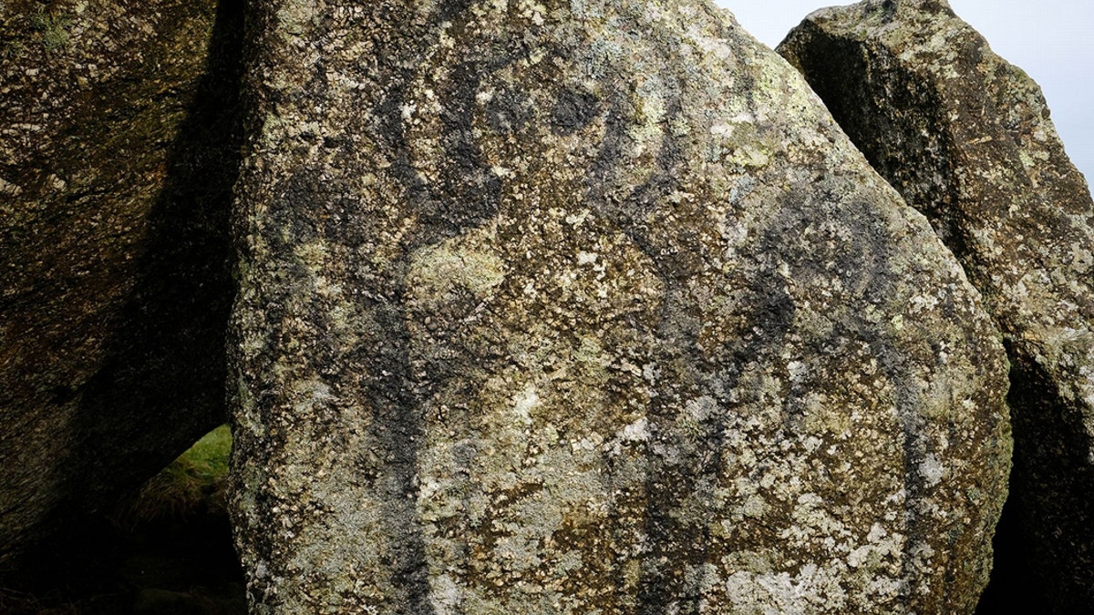 The figures were daubed on one of the granite stones which is part of the Neolithic Mulfra Quoit - that are more than 5,000 years old. The graffiti has caused outrage among the local community and groups that work to protect and preserve the monuments.The stones were believed to have been deliberately targetted due its difficulty to reach up a steep hill in West Cornwall. (Credit: SWNS)