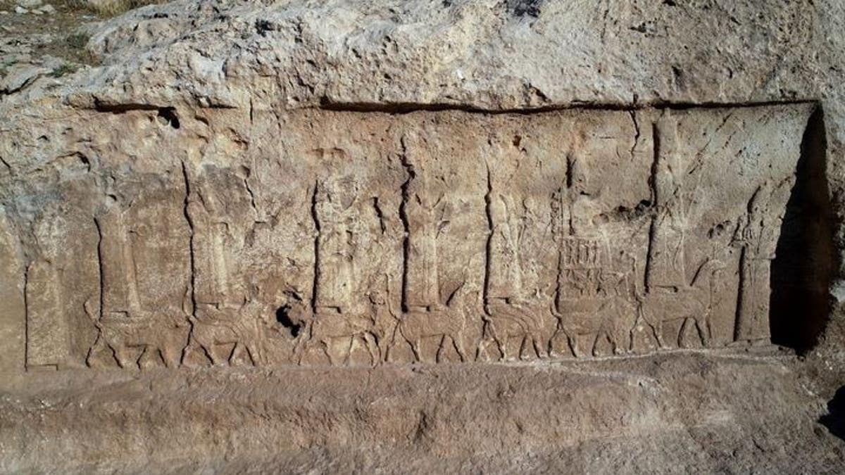 The unearthed panels show a procession of the seven main Assyrian gods and goddesses, standing or seated on mythical animals, and the Assyrian king Sargon II.