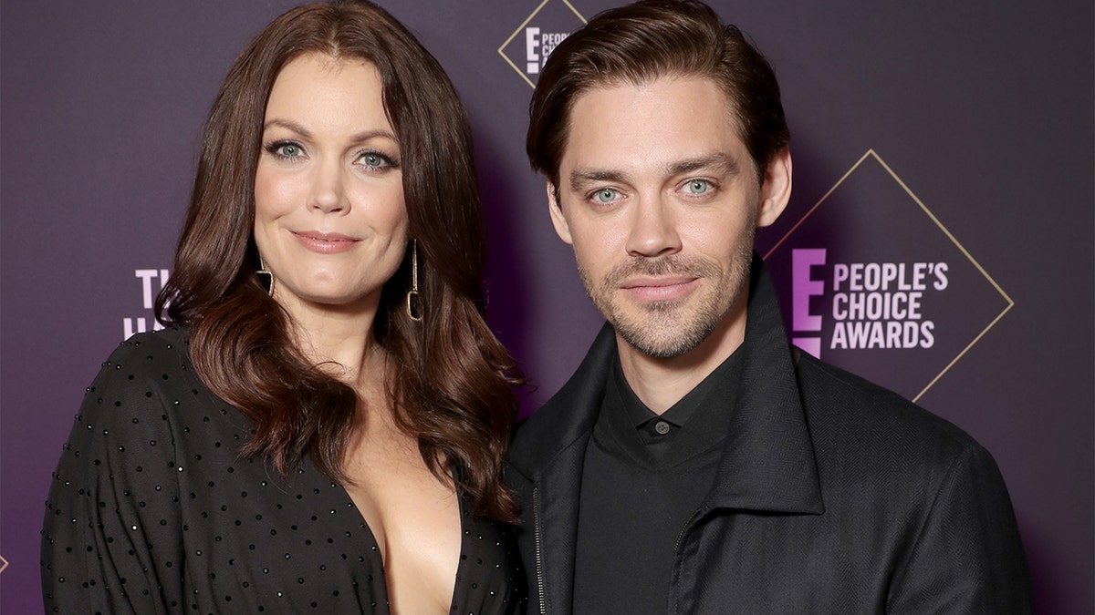 Bellamy Young and Tom Payne pose backstage during the 2019 E! People's Choice Awards held at the Barker Hangar on November 10, 2019.
