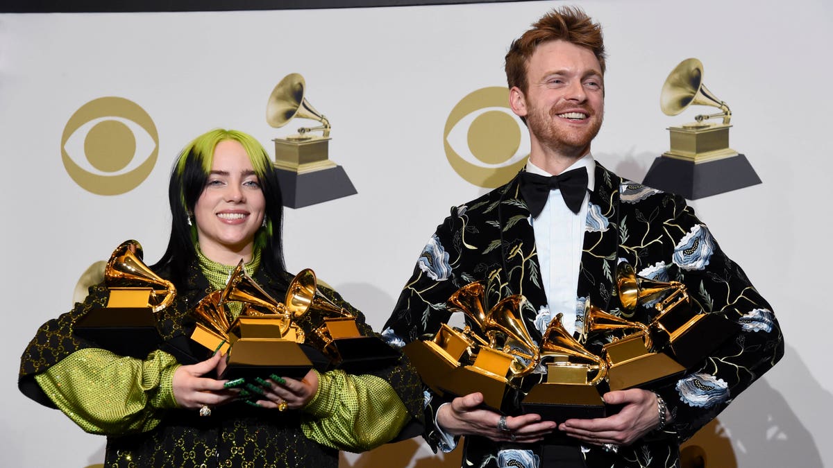 Billie Eilish, left, and Finneas O'Connell pose in the press room with the awards for best album, best engineered album and best pop vocal album for "We All Fall Asleep, Where Do We Go?," best song and record for "Bad Guy," best new artist and best producer, non-classical at the 62nd annual Grammy Awards at the Staples Center on Sunday, Jan. 26, 2020, in Los Angeles. 