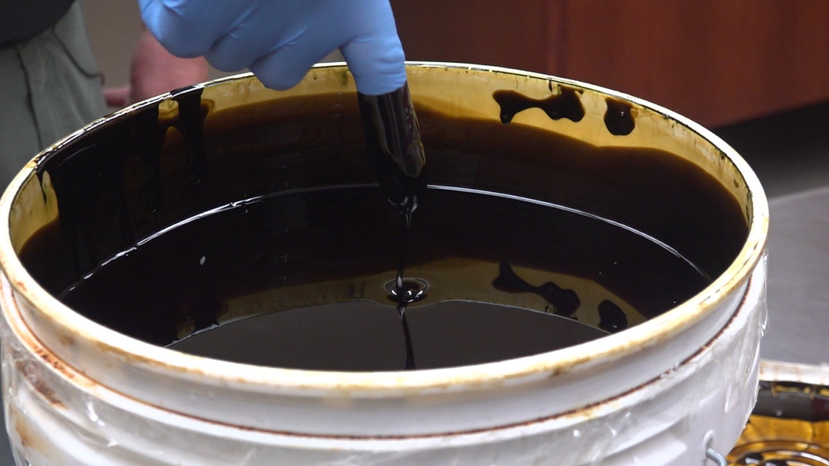 Detective Matthew Shay demonstrates how thick crude oil marijuana is. (Stephanie Bennett/Fox News)