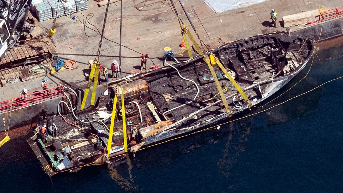 FILE - In this Sept. 12, 2019, file photo, the burned hull of the Conception is brought to the surface by a salvage team off Santa Cruz Island in the Santa Barbara Channel in Southern California. (Brian van der Brug/Los Angeles Times via AP, File)