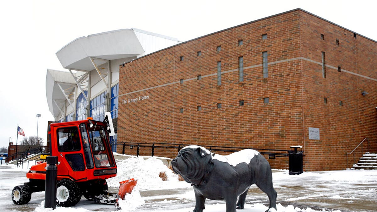 A statue depicting Drake University's bulldog mascot stands outside a university venue that will host a Democratic presidential primary as workers clear snow, Monday, Jan. 13, 2020, in Des Moines, Iowa. The debate is scheduled for Tuesday. (AP Photo/Patrick Semansky)