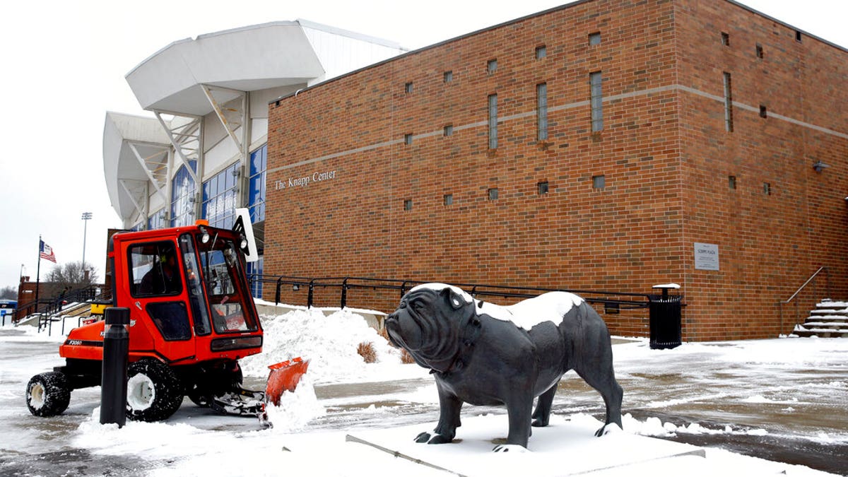 A statue depicting Drake University's bulldog mascot stands outside a university venue that will host a Democratic presidential primary as workers clear snow, Monday, Jan. 13, 2020, in Des Moines, Iowa. The debate is scheduled for Tuesday. (AP Photo/Patrick Semansky)