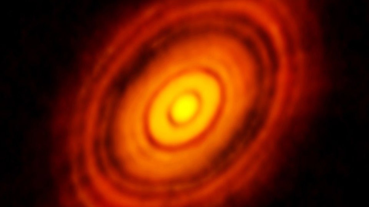The Atacama Large Millimeter/Submillimeter Array (ALMA) in Chile captured this picture of disks that formed around a young star about 450 light years away from our planet. Now, scientists are proposing that similar disks could have formed around our sun in the early solar system, creating the seeds for our planets. (Credit: ALMA (ESO/NAOJ/NRAO), NSF)