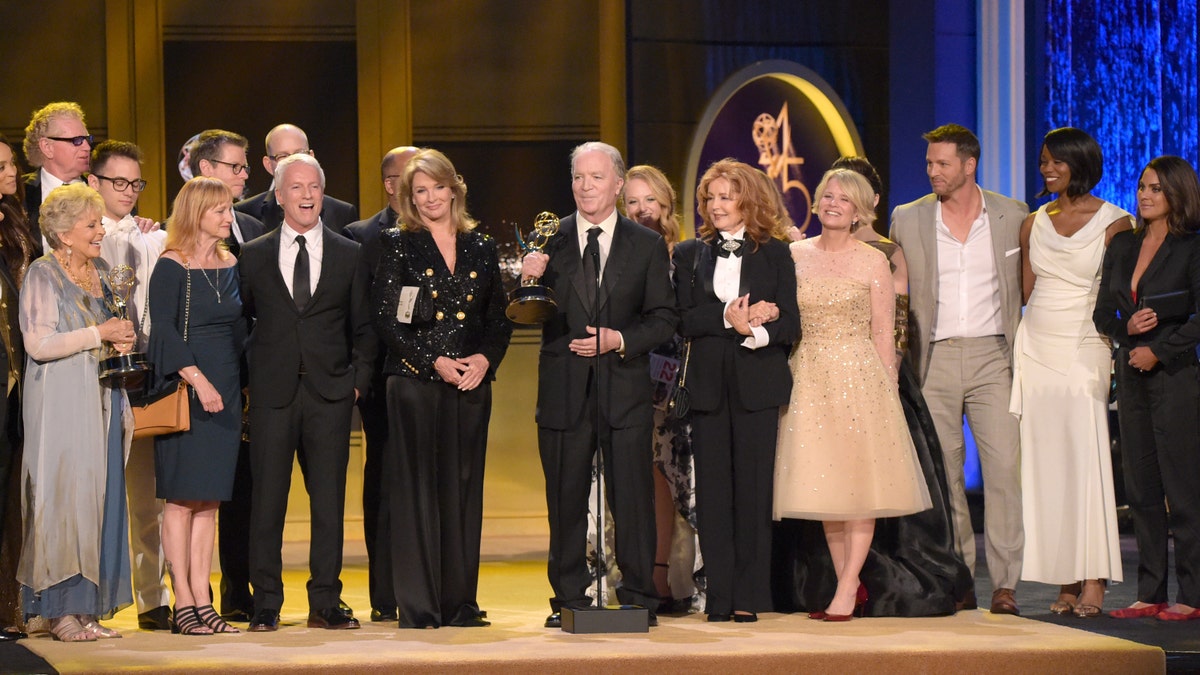 This April 29, 2018 file photo shows Ken Corday, center, and the cast and crew of "Days of Our Lives" accepting the award for outstanding drama series at the 45th annual Daytime Emmy Awards in Pasadena, Calif.?