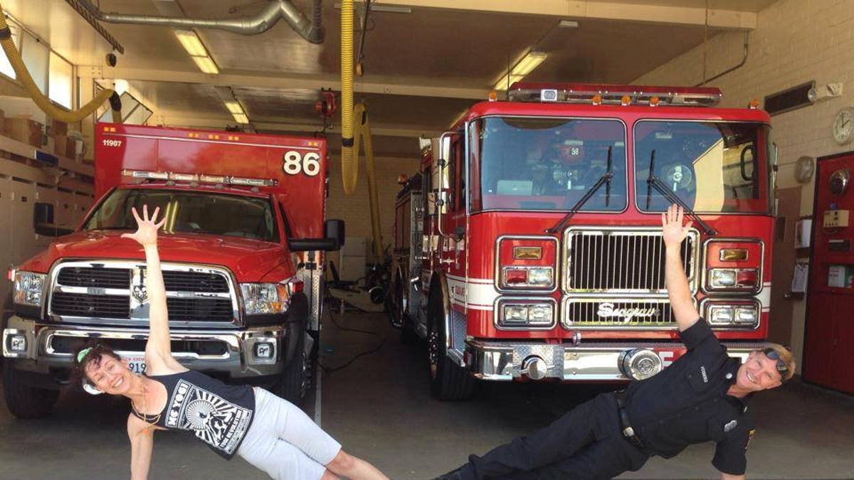 Olivia Mead does side plank outside the fire department.