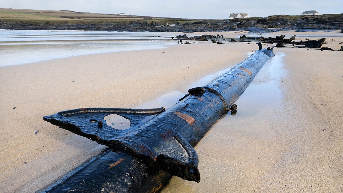 102 years after it declared a total loss, the metal ribs of the 60ft steel-hulled SV Carl began emerging from the sand just before Christmas. (Credit: SWNS)