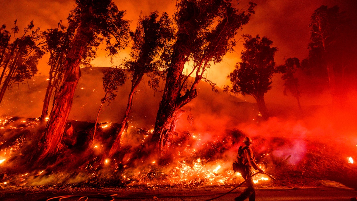 FILE - In this Nov. 1, 2019, file photo, flames from a backfire consume a hillside as firefighters battle the Maria Fire in Santa Paula, Calif. The decade that just ended was by far the hottest ever measured on Earth, capped off by the second-warmest year on record, NASA and the National Oceanic and Atmospheric Administration reported Wednesday, Jan. 15, 2020. (AP Photo/Noah Berger, File)