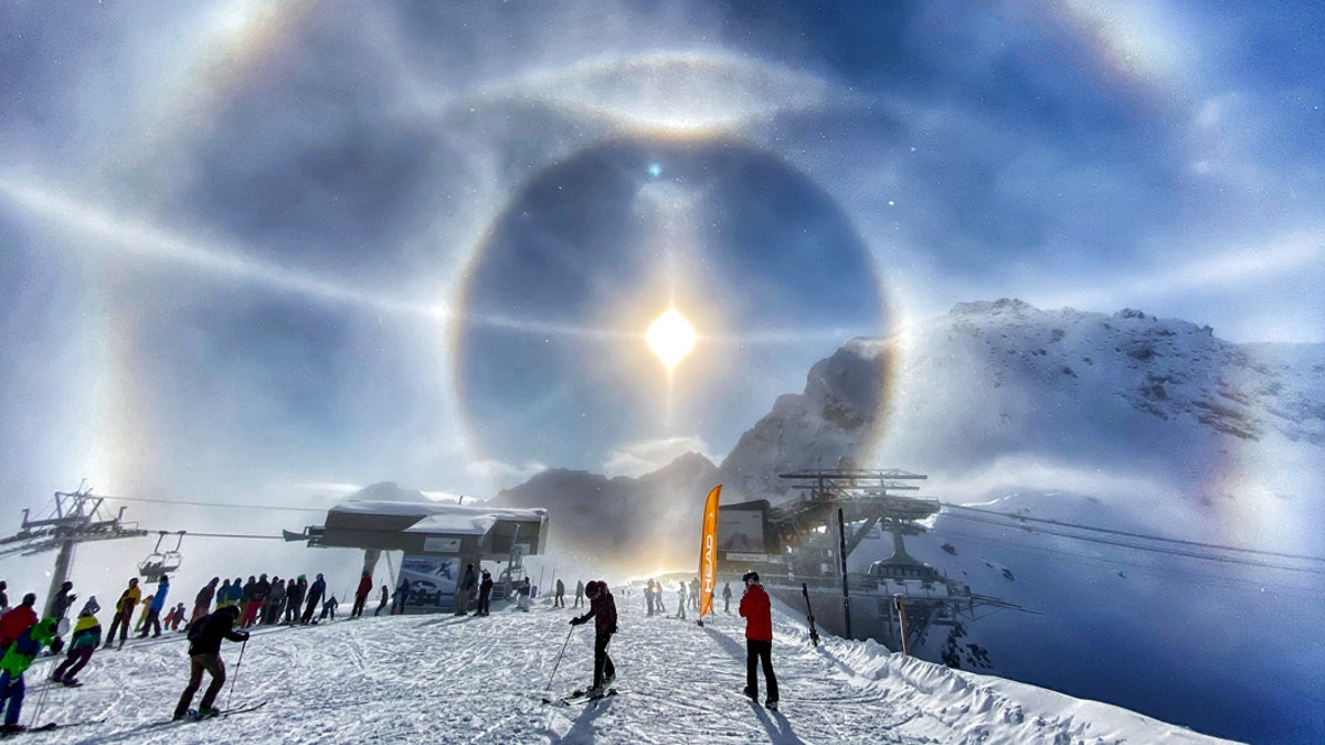 This breathtaking photo shows the moment that ice crystals froze in midair, causing a halo effect around the beaming Sun. (Credit: SWNS)