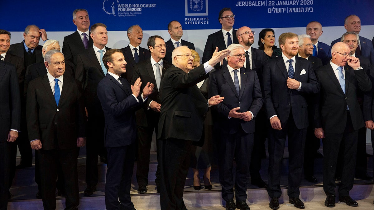 World leaders try to organize themselves for a group photograph following a dinner reception as Israel's President Reuven Rivlin, center, thanks his chef at his official residence in Jerusalem on Wednesday, Jan. 22, 2020. Dozens of world leaders descended upon Jerusalem Thursday for the largest-ever gathering focused on commemorating the Holocaust and combating modern-day anti-Semitism. (Heidi Levine/Pool photo via AP)