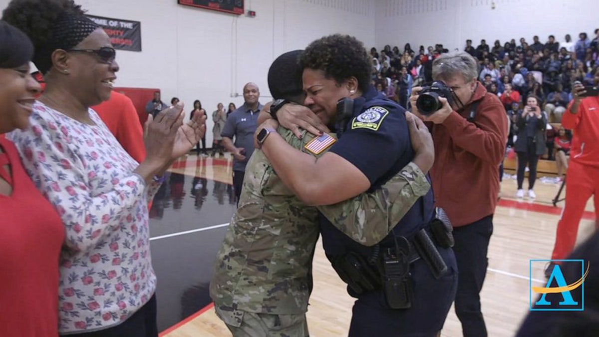 In a heartwarming video that has since gone viral, Aquil jogged out from behind the basketball players and cheerleaders in his fatigues, to embrace his emotional mom with a bear hug.