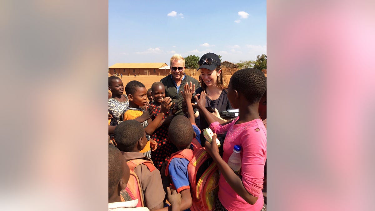 White House staffer Carolina Hurley greeting a group of schoolchildren during her visit to the Chipala Primary School in Lilongwe, Malawi.