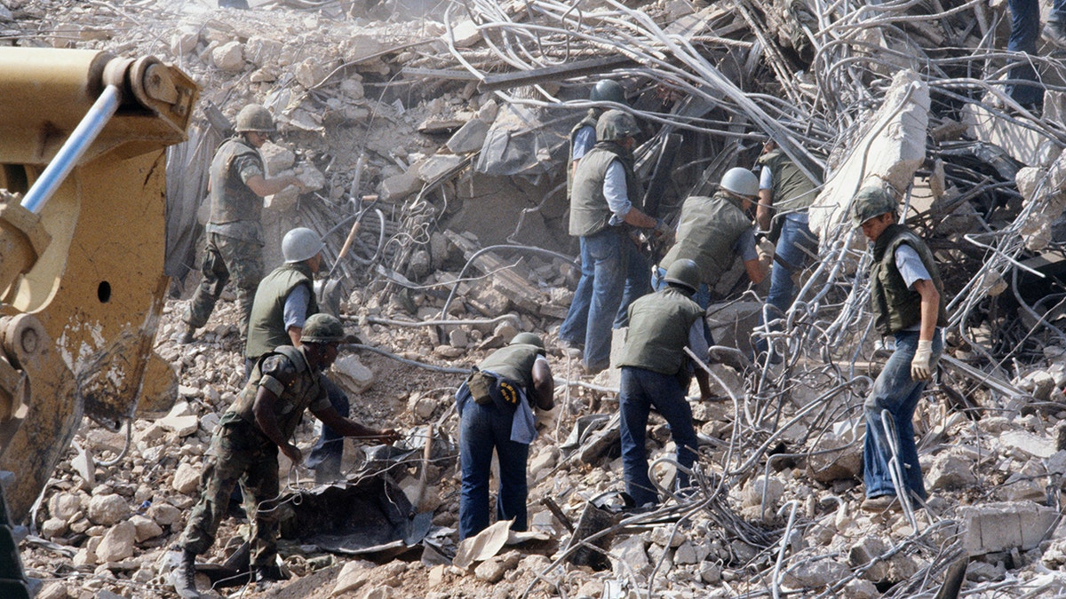 U.S. Marines search for survivors and bodies in the rubble – all that was left of their barracks in Beirut – after a suicide car bomb was driven into the building and detonated in 1983, killing 241 U.S. service members and wounding over 60.