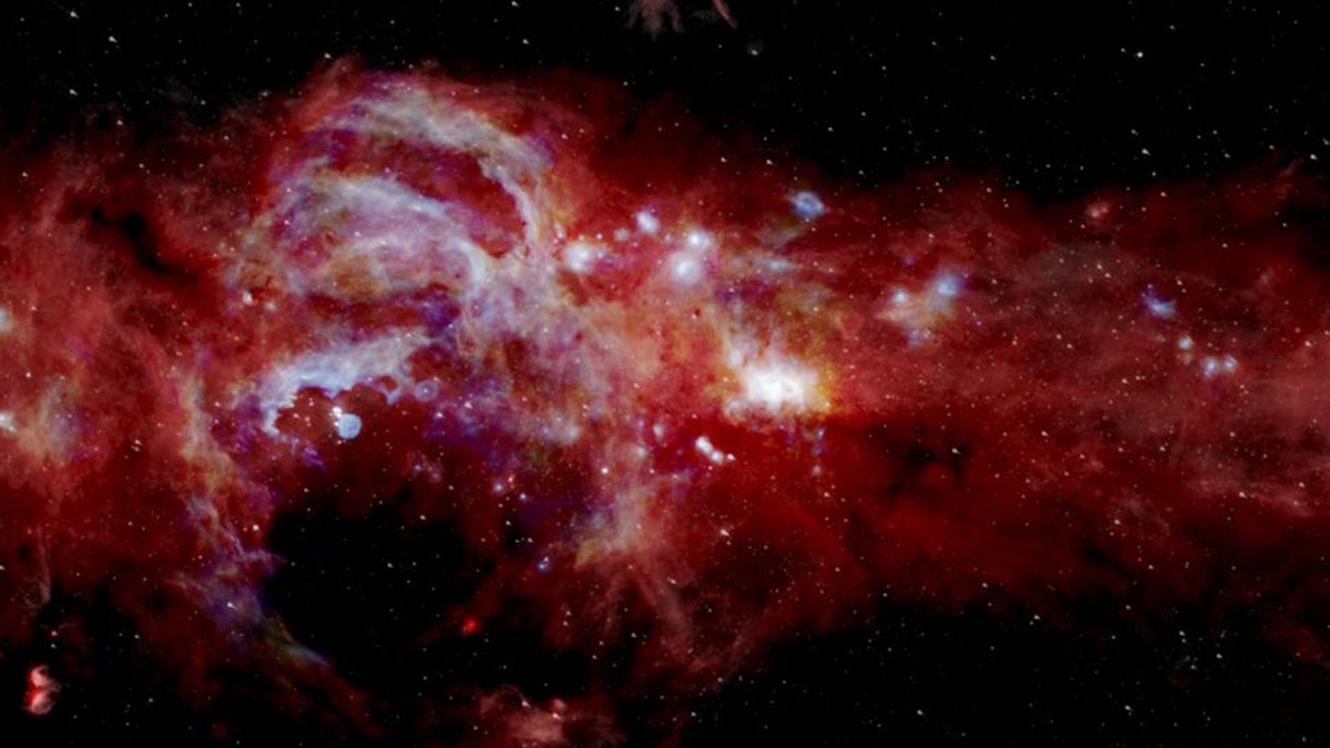 A composite image shows infrared light from swirls of gas and dust at the center of the Milky Way. (Full size image below.) (Credit: NASA/SOFIA/JPL-Caltech/ESA/Herschel)