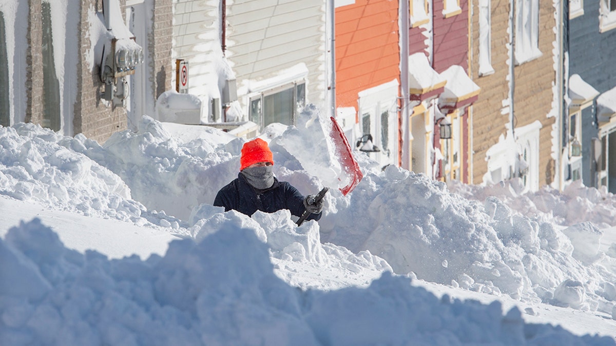 A resident digs out his walkway in St. John's Newfoundland on Saturday, Jan. 18, 2020. Andrew Vaughan/The Canadian Press via AP)