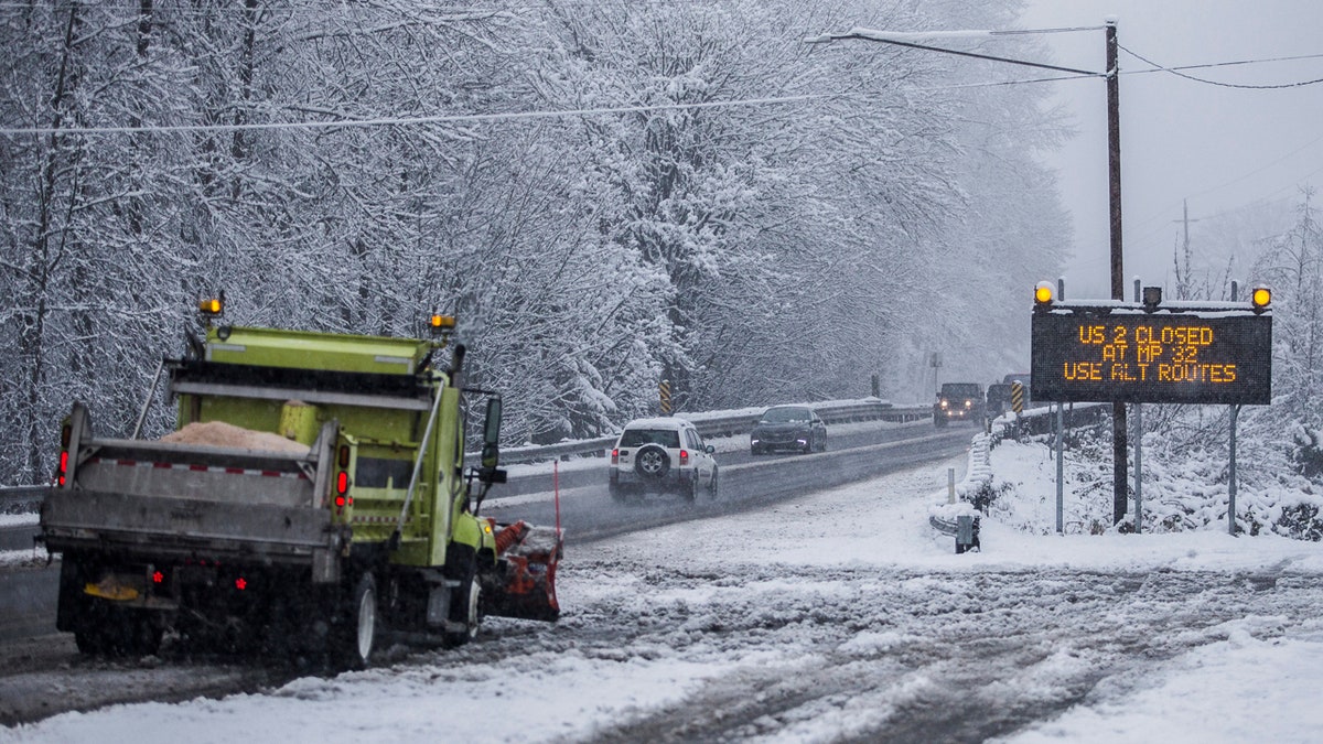 A snow plow waits at the side of a road in Monroe, Wash., Monday, Jan. 13, 2020.