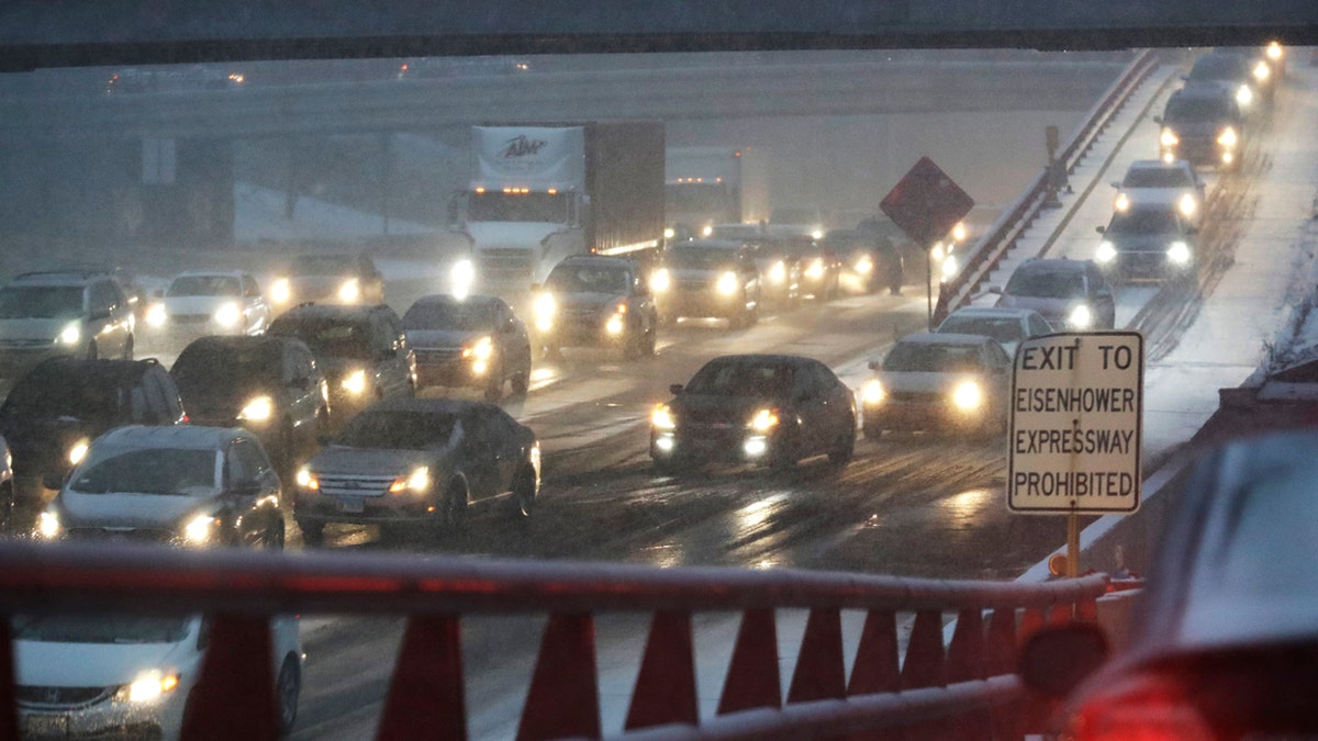 Heavy traffic is seen on Eisenhower Expressway in Chicago, Friday, Jan. 17, 2020. Hundreds of flights were canceled as a winter storm hits the city during evening commute Friday, creating a sloppy rush hour. (AP Photo/Nam Y. Huh)