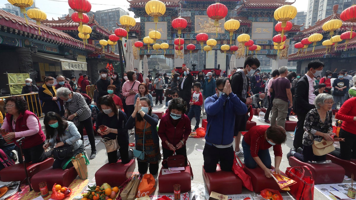 People pray at the Wong Tai Sin Temple, in Hong Kong, Saturday, Jan. 25, 2020 to celebrate the Lunar New Year which marks the Year of the Rat in the Chinese zodiac.
