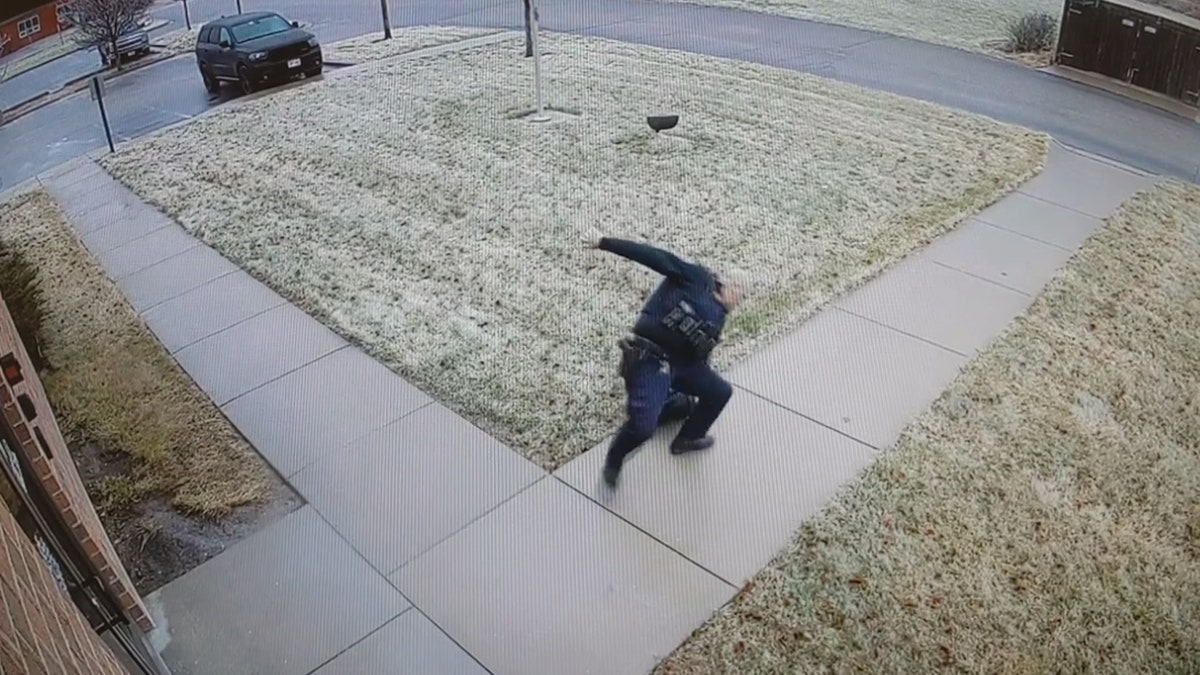 A police officer can be seen slipping and falling on black ice over the weekend in Wisconsin.