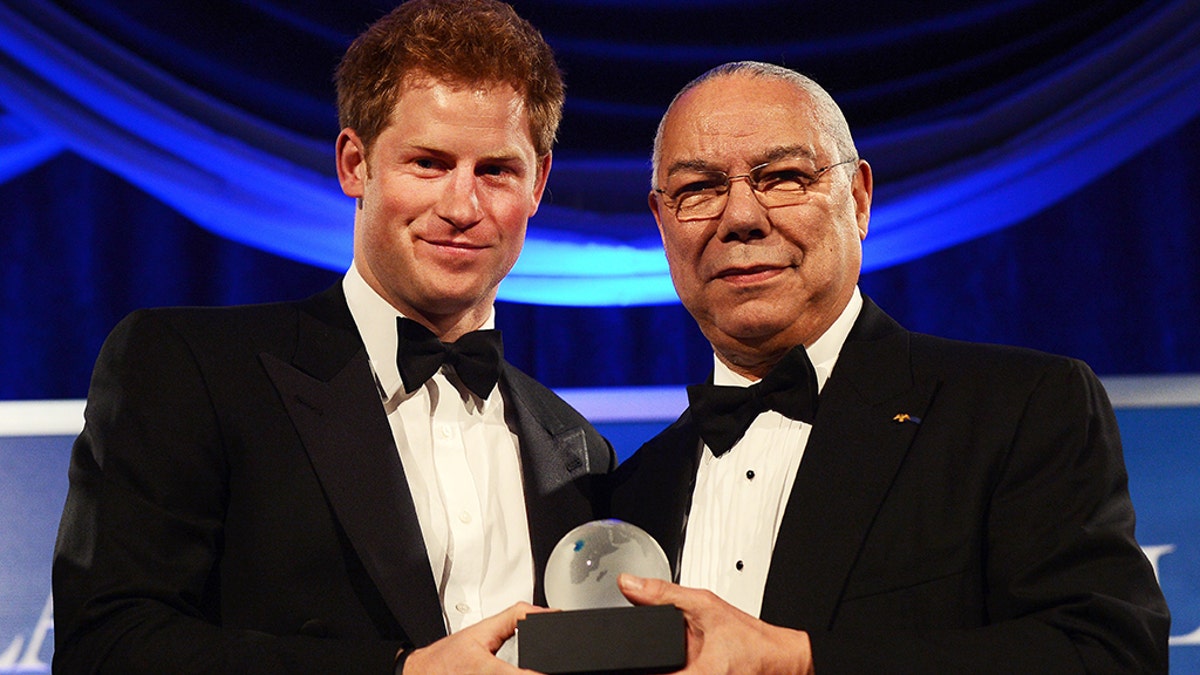 Prince Harry receives the Distinguished Humanitarian Leadership Award presented by former Secretary of State Colin Powell during the Atlantic Council 2012 Annual Awards Dinner at a hotel in Washington, DC, on May 7, 2012. Prince Harry joined a black-tie dinner in Washington to accept a humanitarian prize for his work supporting charities that help injured British and U.S. military personnel.