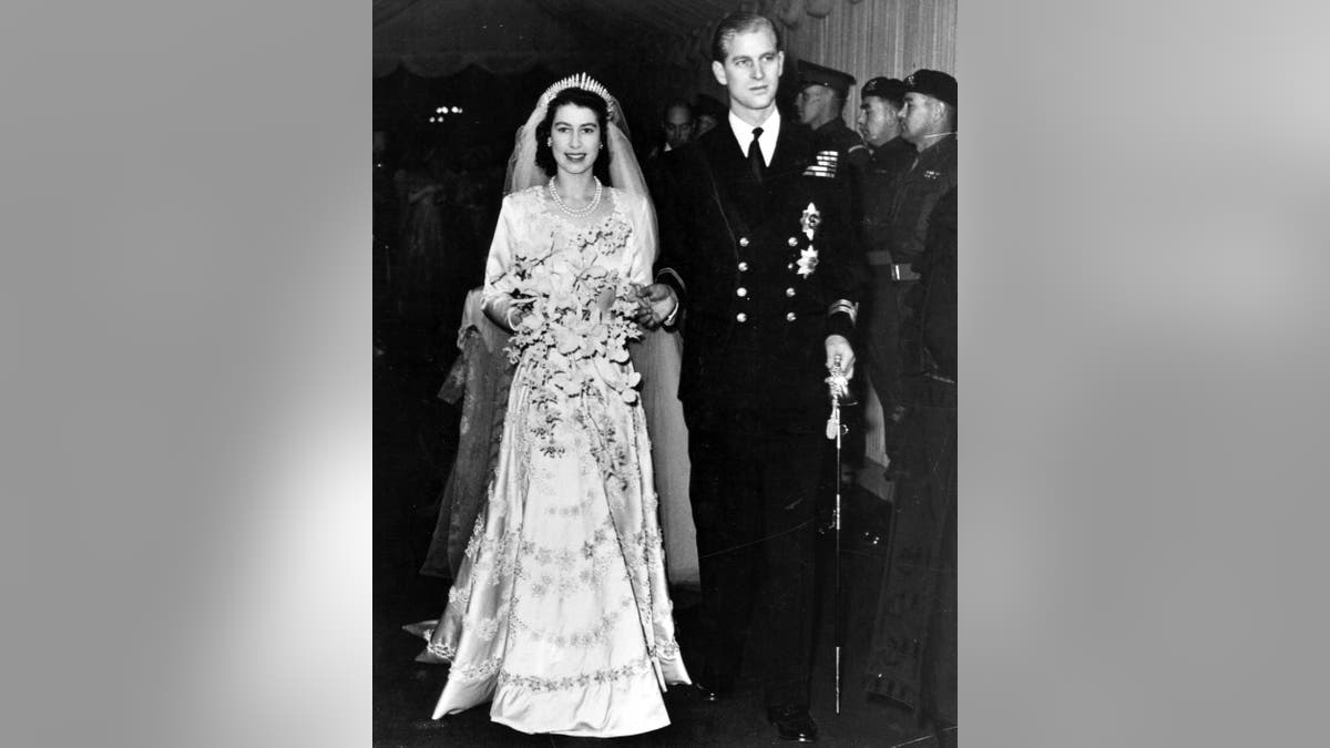 Queen Elizabeth II, as Princess Elizabeth, and her husband the Duke of Edinburgh, styled Prince Philip in 1947, on their wedding day. She became queen on her father King George VI's death in 1952.
