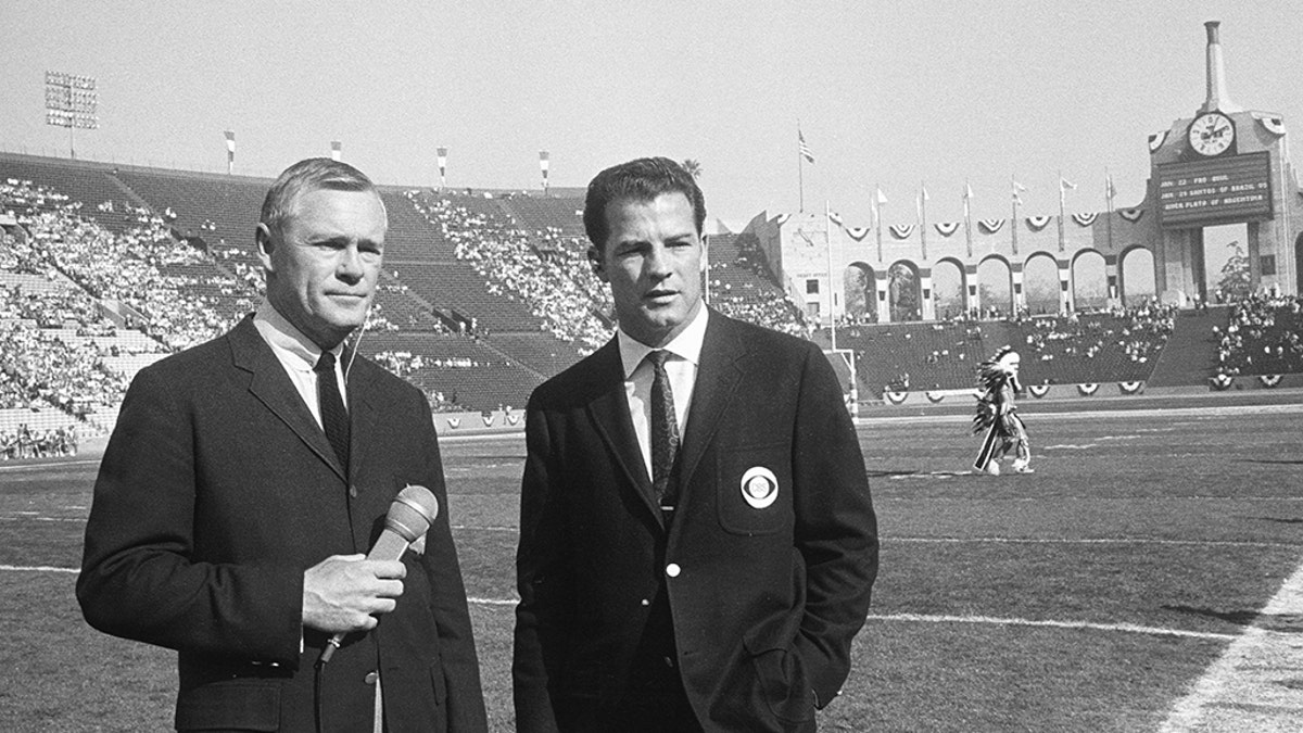 Sports commentators Paul Christman, for NBC, and Frank Gifford, for CBS, on Jan. 15, 1967. (Photo by CBS via Getty Images)