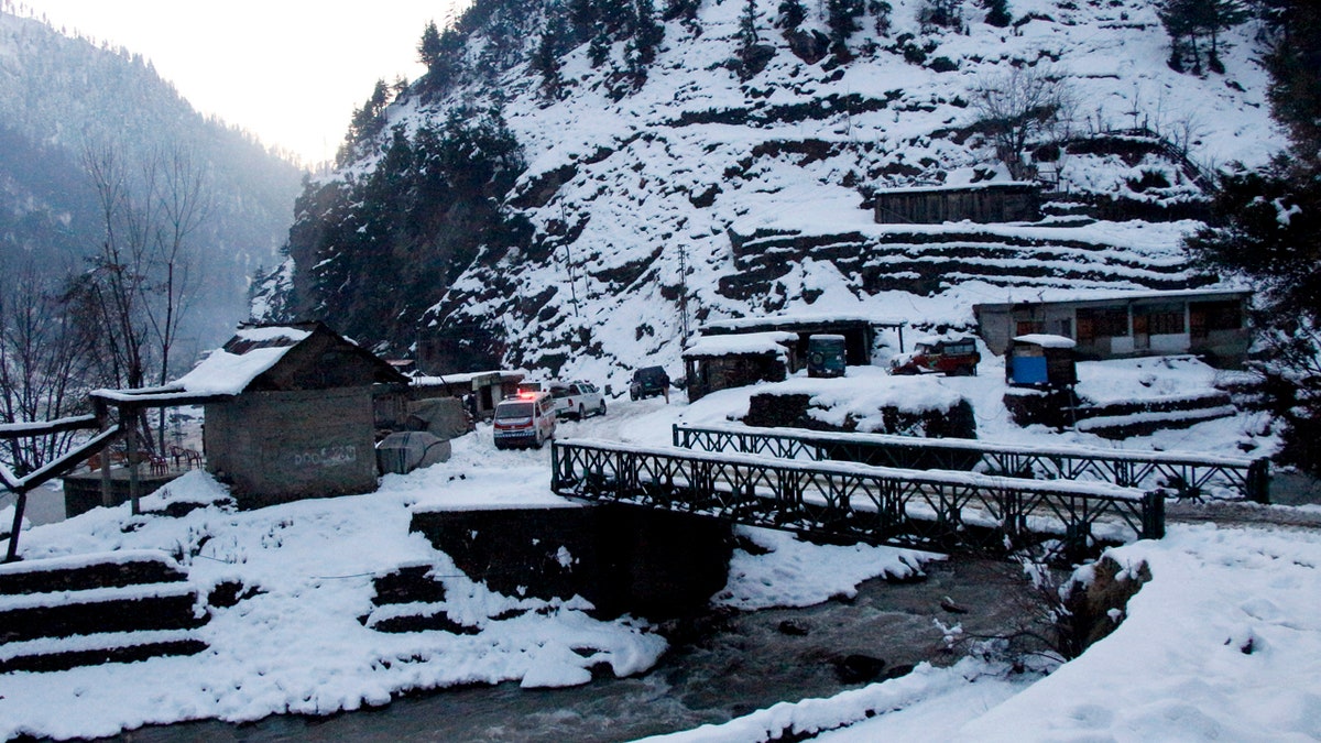 An ambulance heading to an area hit by avalanches waits for a blocked road to be opened, in Keran, a small town in Neelum Valley, Pakistan-administered Kashmir, Tuesday, Jan. 14, 2020.