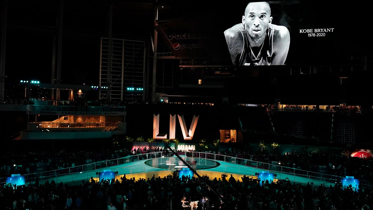 Spectators observe a moment of silence for Kobe Bryant before Opening Night for the NFL Super Bowl 54 football game between the Kansas City Chiefs and the San Francisco 49ers Monday, Jan. 27, 2020, at Marlins Park in Miami. (AP Photo/Morry Gash)