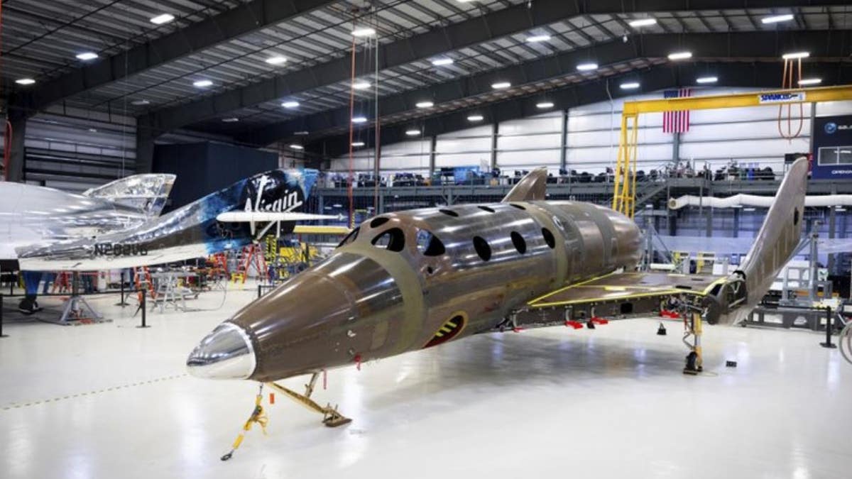 This photo released by Virgin Galactic shows the company's next passenger spaceship standing on its landing gear.