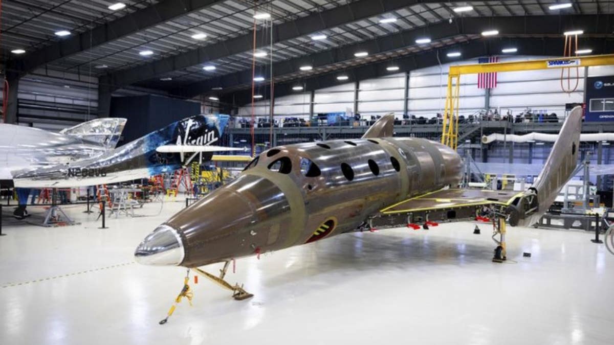 This photo released by Virgin Galactic shows the company's next passenger spaceship standing on its landing gear.