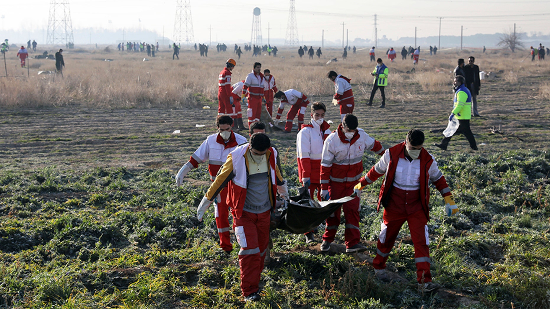 Rescue workers recover the bodies of victims at the crash site. (AP)