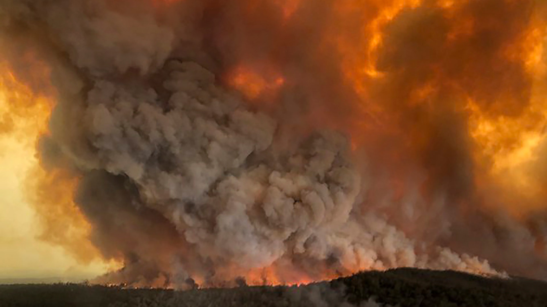Wildfires rage under plumes of smoke in Bairnsdale, Australia, Dec. 30, 2019.