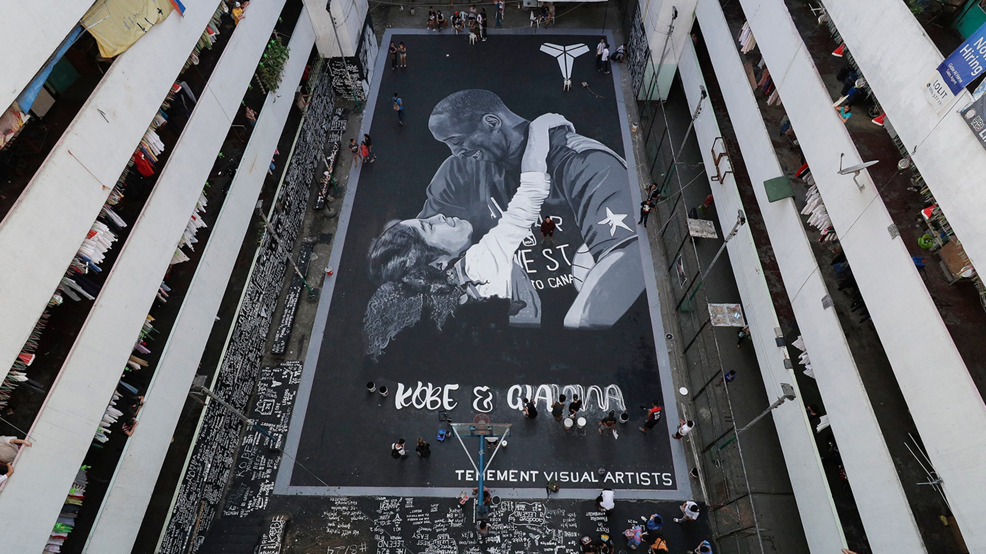 Artists put on the finishing touches on a giant mural of former NBA basketball player Kobe Bryant and daughter Gianna at a basketball court in Taguig, Philippines, Jan. 28, 2020. 