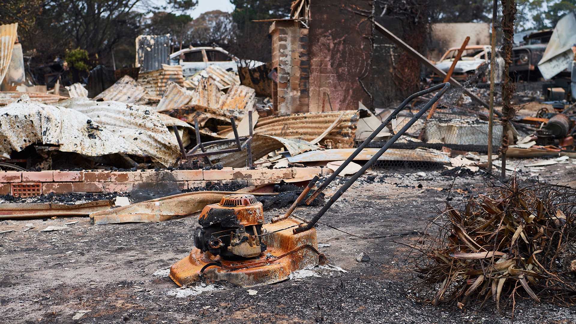 A burnt house and lawnmower are all that are left after a wildfire moved through Wingello, Australia, Jan. 6, 2020.