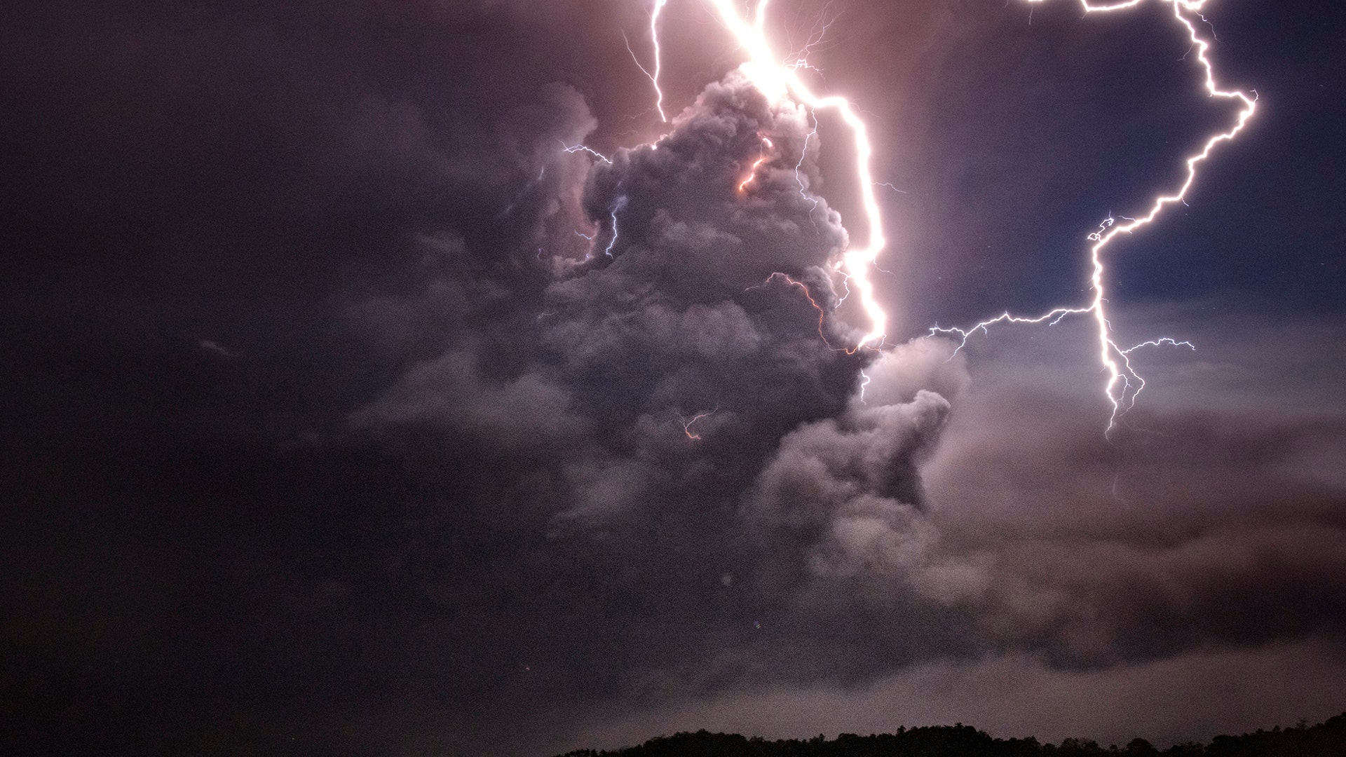 Lightning strikes as ash spew from the crater of the Taal Volcano during an eruption seen from Tagaytay City, Philippines, January 12, 2020. 