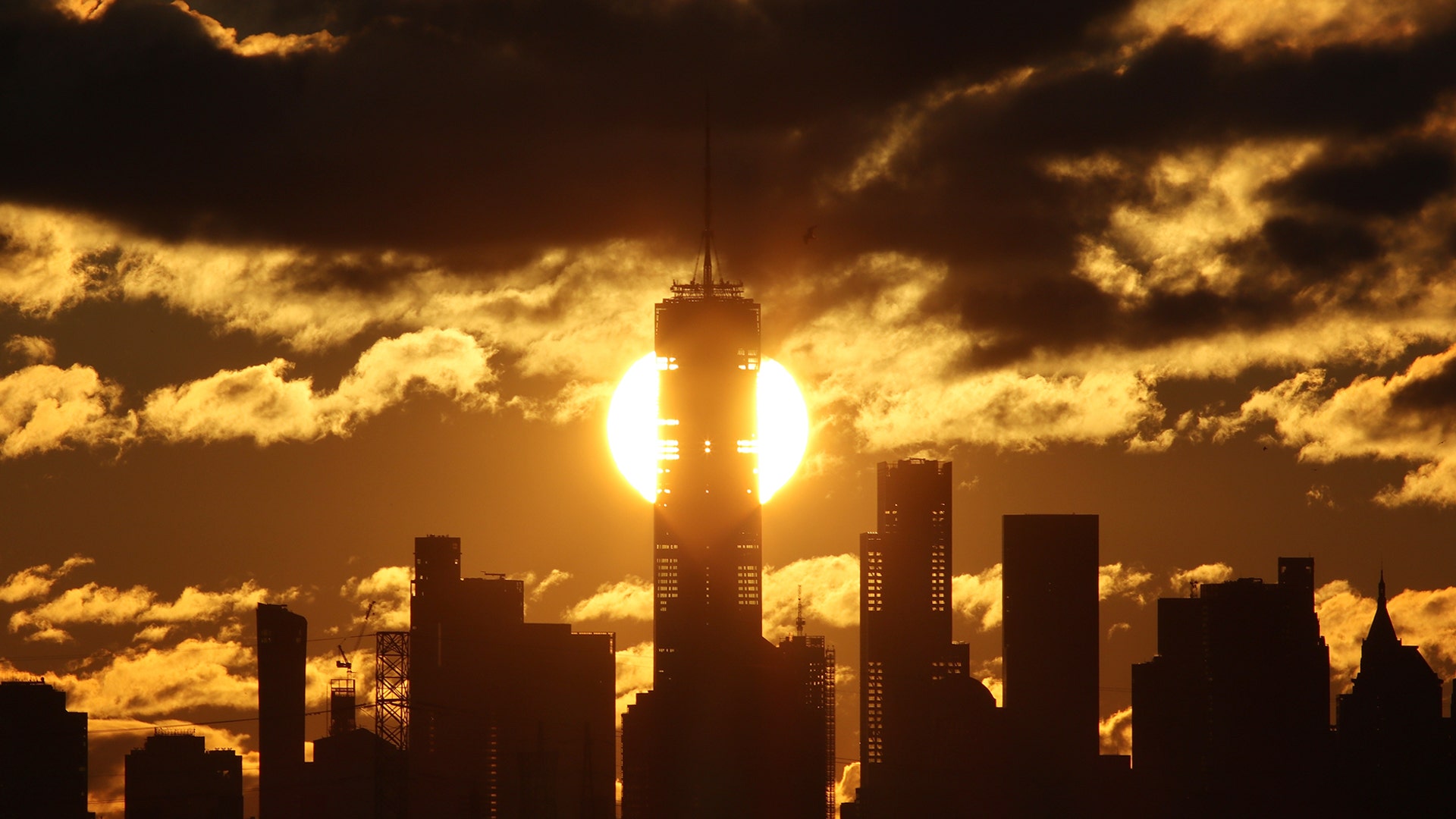 The sun rises behind the skyline of lower Manhattan and One World Trade Center in New York City, Jan. 5, 2020 