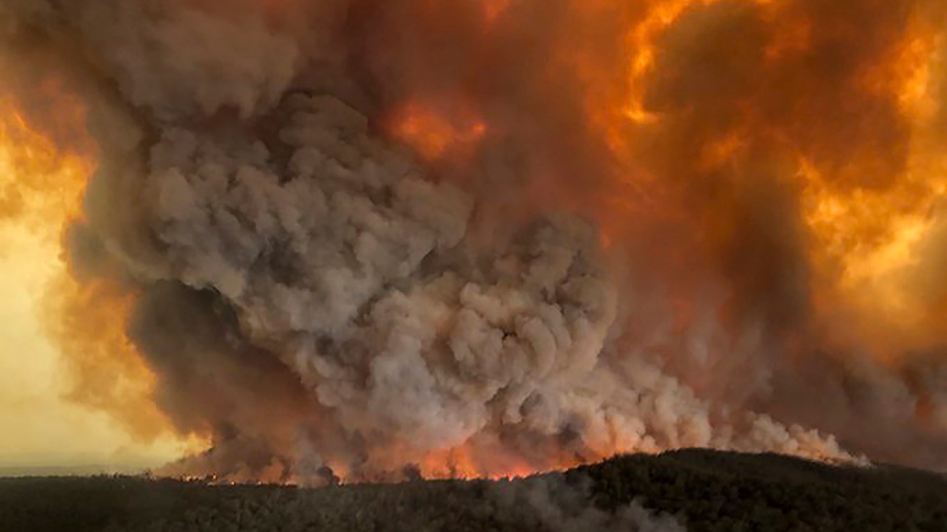 Wildfires rage under plumes of smoke in Bairnsdale, Australia, Dec. 30, 2019.