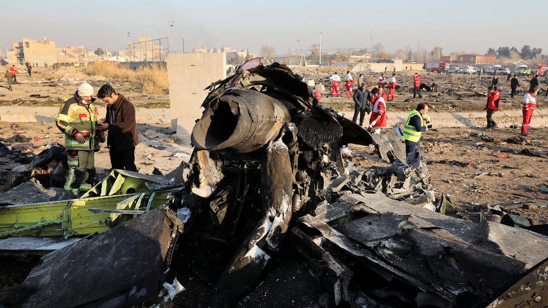 Debris is seen from a Ukrainian plane that crashed as authorities work at the scene in Shahedshahr, southwest of the capital Tehran, Iran, Jan. 8, 2020.