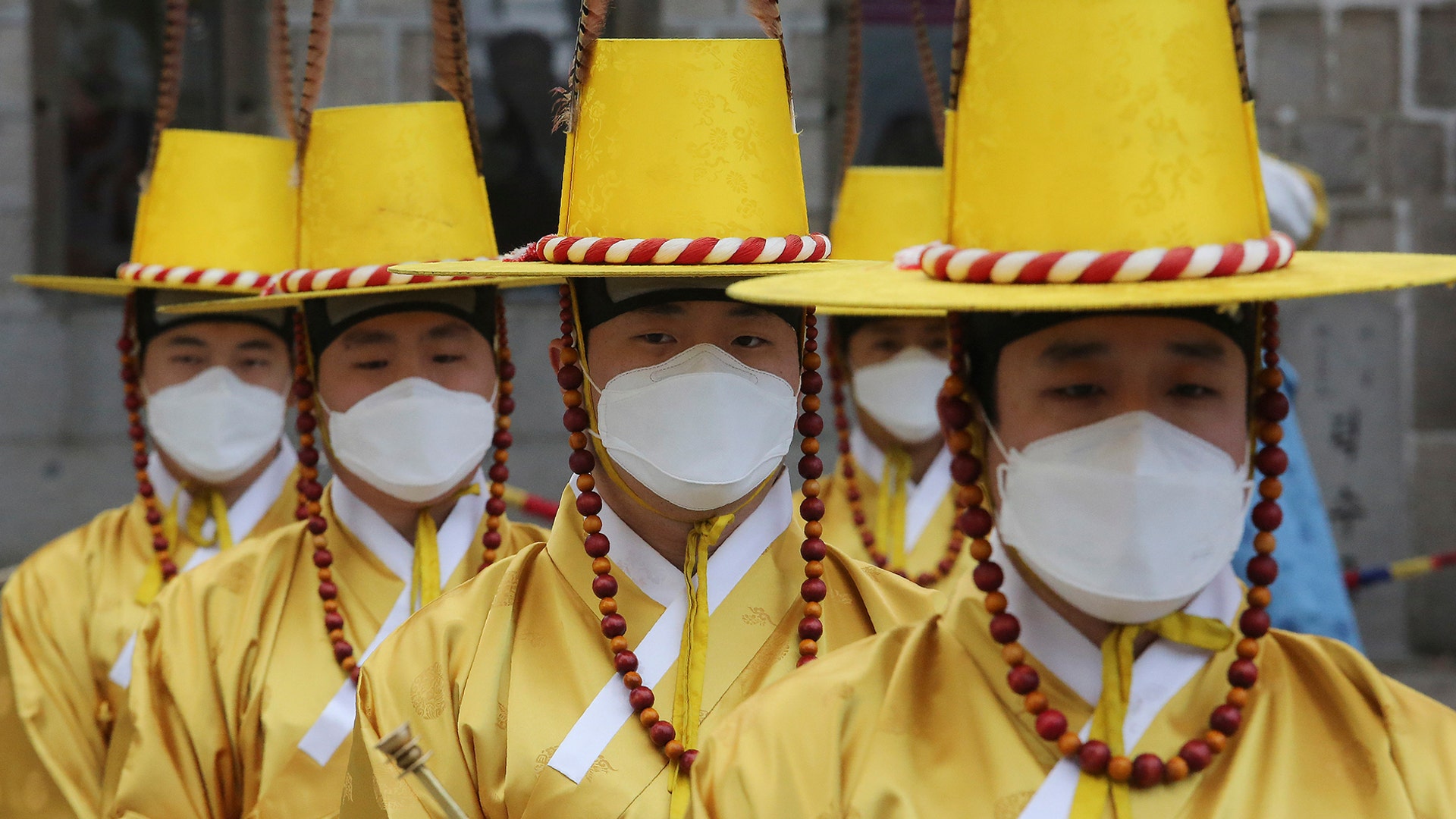 Imperial guards wear protective face masks during a reenactment of the Royal Guards Changing Ceremony in front of Deoksu Palace in Seoul, South Korea, Jan. 30, 2020.
