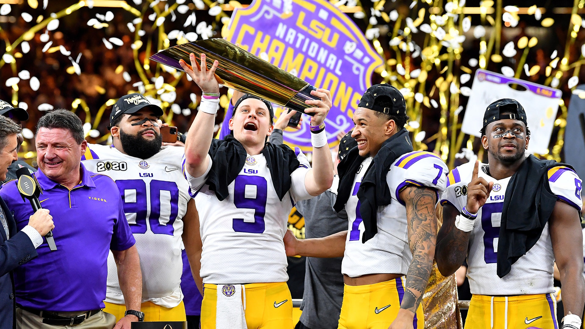 Joe Burrow of the LSU Tigers raises the National Championship Trophy with Ed Orgeron, Grant Delpit, Patrick Queen, and Rashard Lawrence after defeating the Clemson Tigers in the College Football Playoff National Championship game in New Orleans, Jan. 13, 2020.