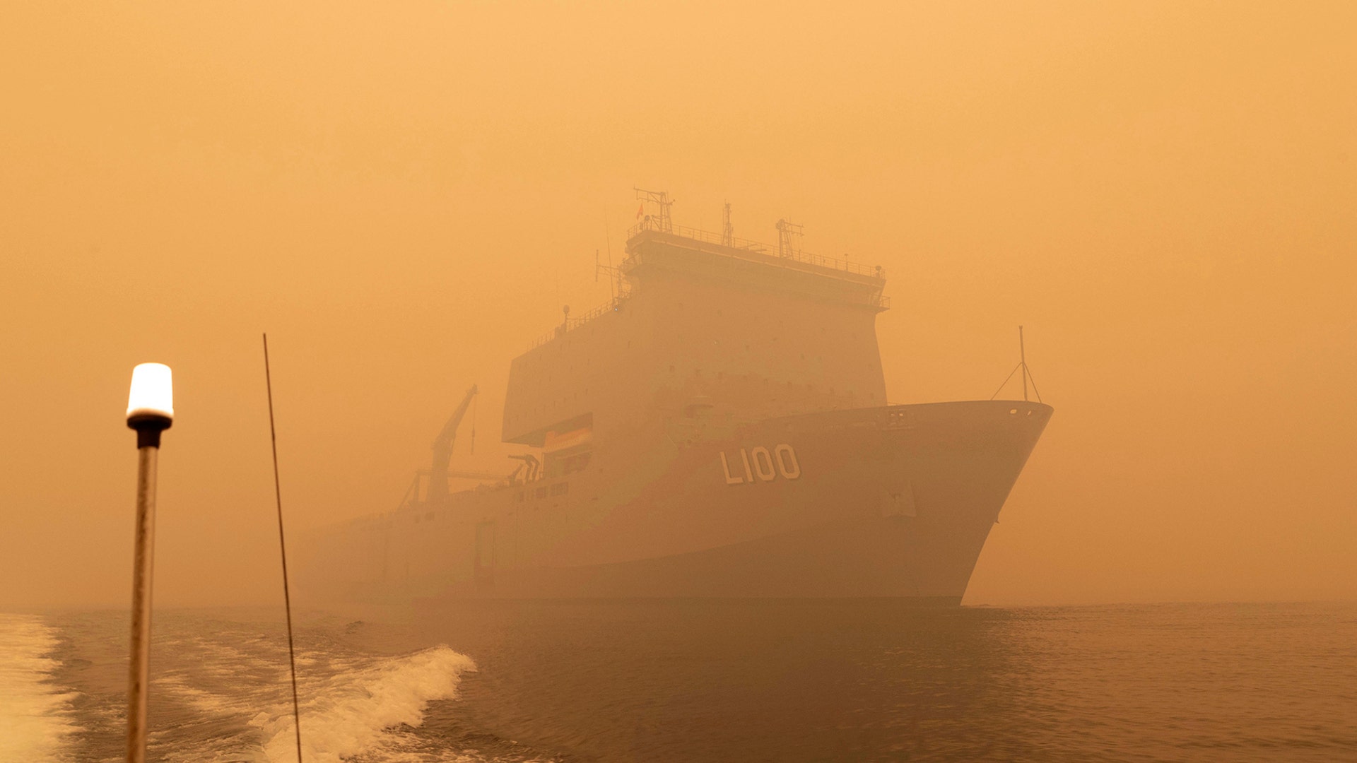 The HMAS Choules sails off the coast of Mallacoota, Victoria, Australia to provide support to people cut off by bush fires, Jan. 2, 2020