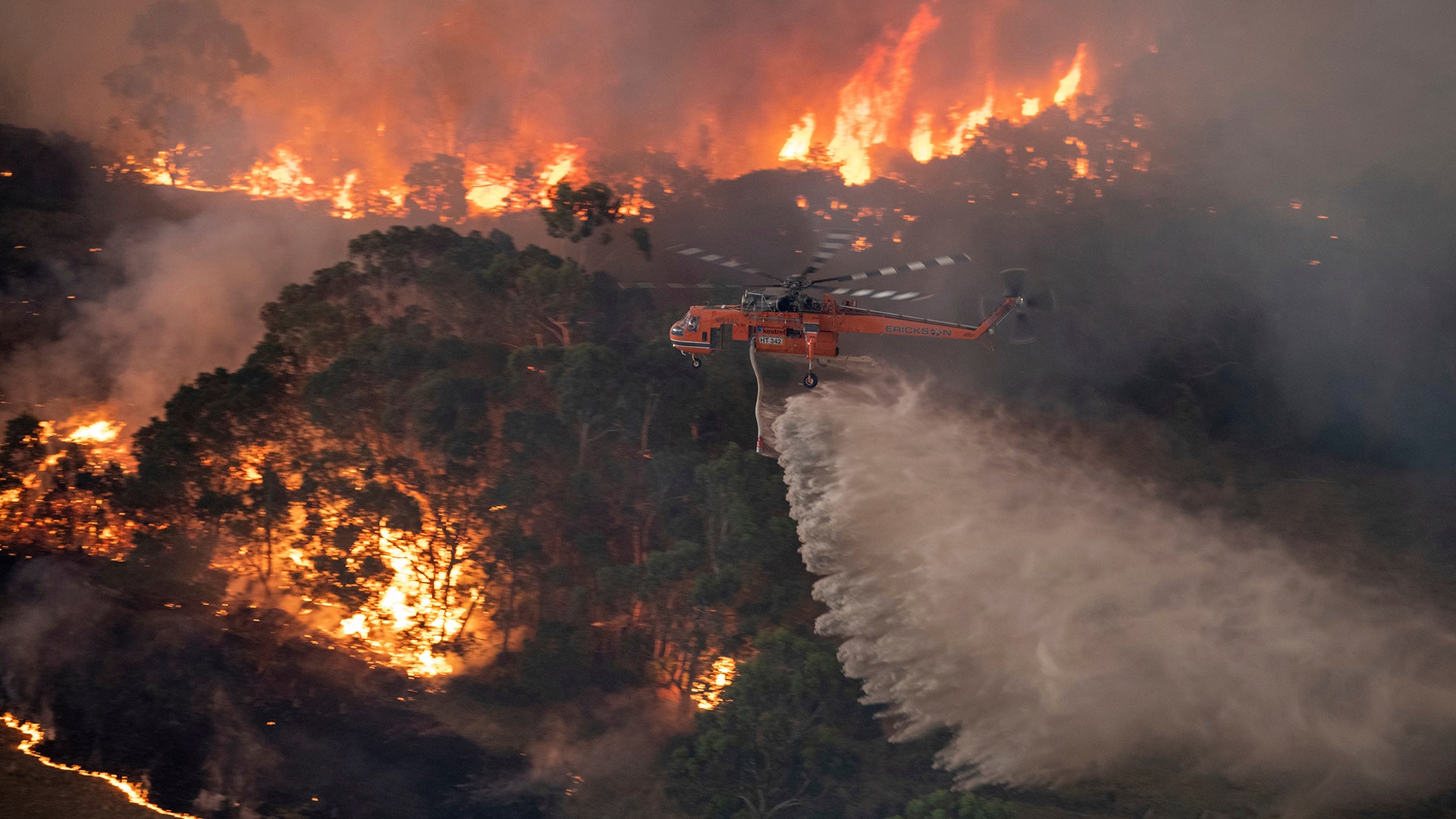A helicopter tackles a wildfire in East Gippsland, Victoria, Australia, Dec. 30, 2019.