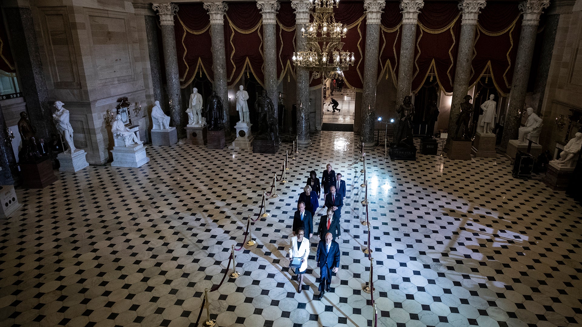 The articles of impeachment are carried through Statuary Hall as they pass from the House to the Senate at the U.S. Capitol in Washington, Jan. 15, 2020. 