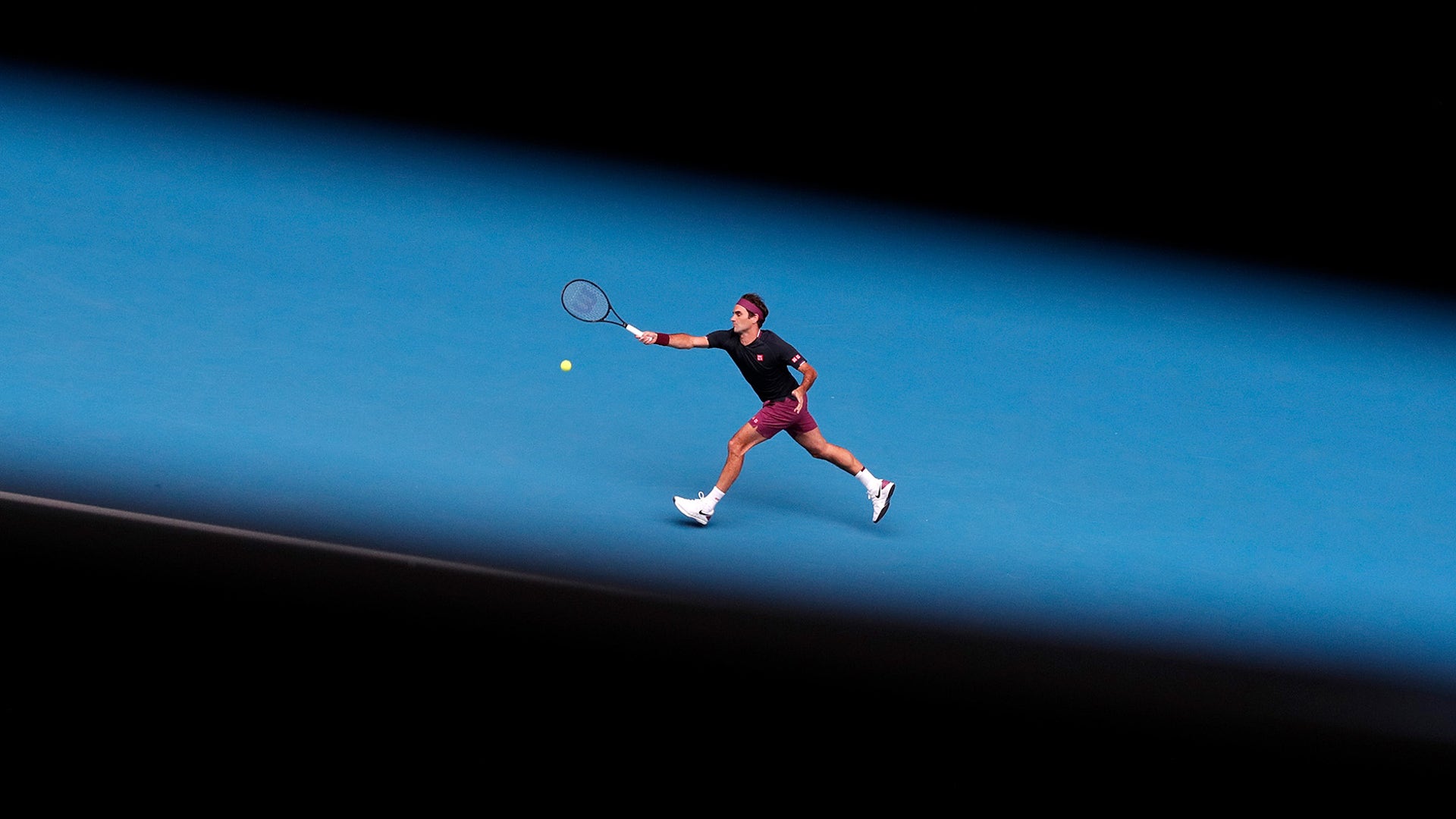 Switzerland's Roger Federer hits a forehand return to United States' Steve Johnson during their first-round singles match at the Australian Open tennis championship in Melbourne, Australia, Jan. 20, 2020. 