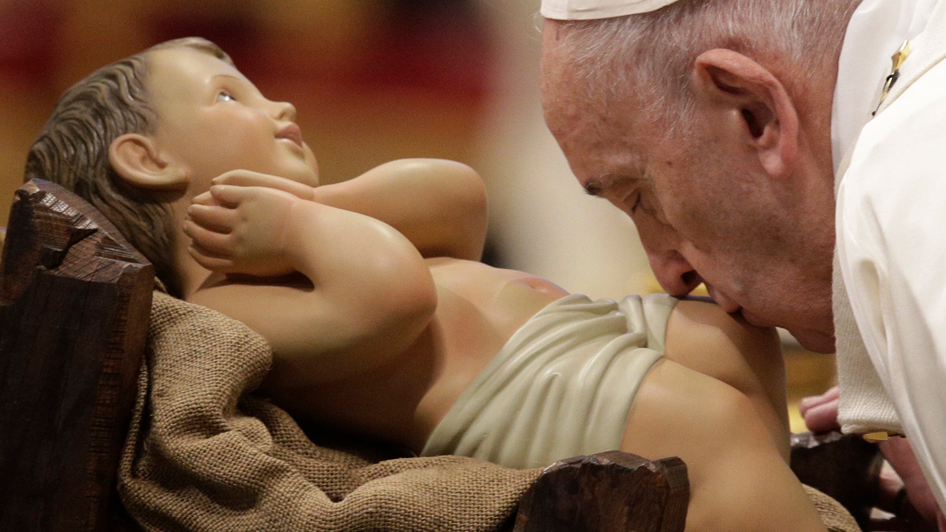 Pope Francis kisses a statue of Baby Jesus as he presides over a Mass for the solemnity of St. Mary at the beginning of the new year, in St. Peter's Basilica at the Vatican, Jan. 1, 2020.