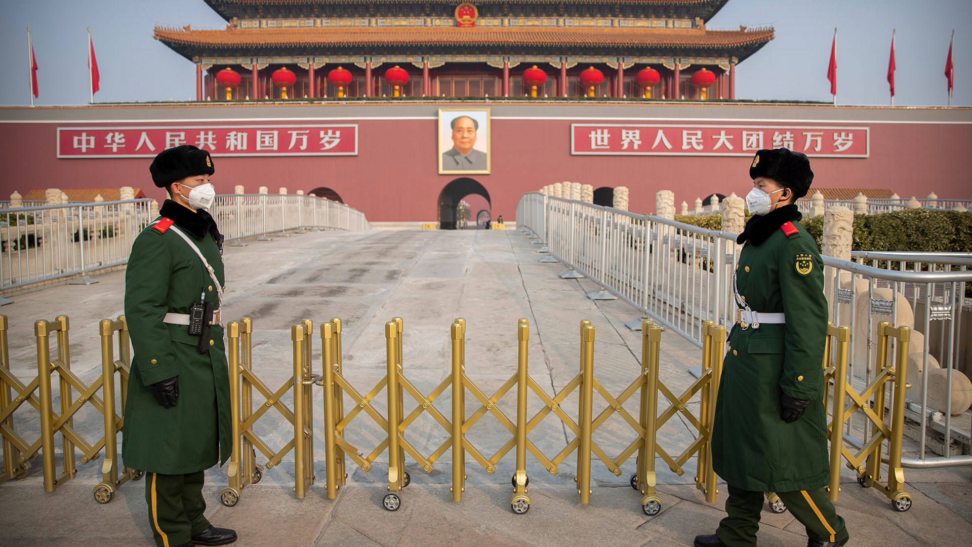 Paramilitary police wear face masks as they stand guard at Tiananmen Gate adjacent to Tiananmen Square in Beijing, Jan. 27, 2020. 
