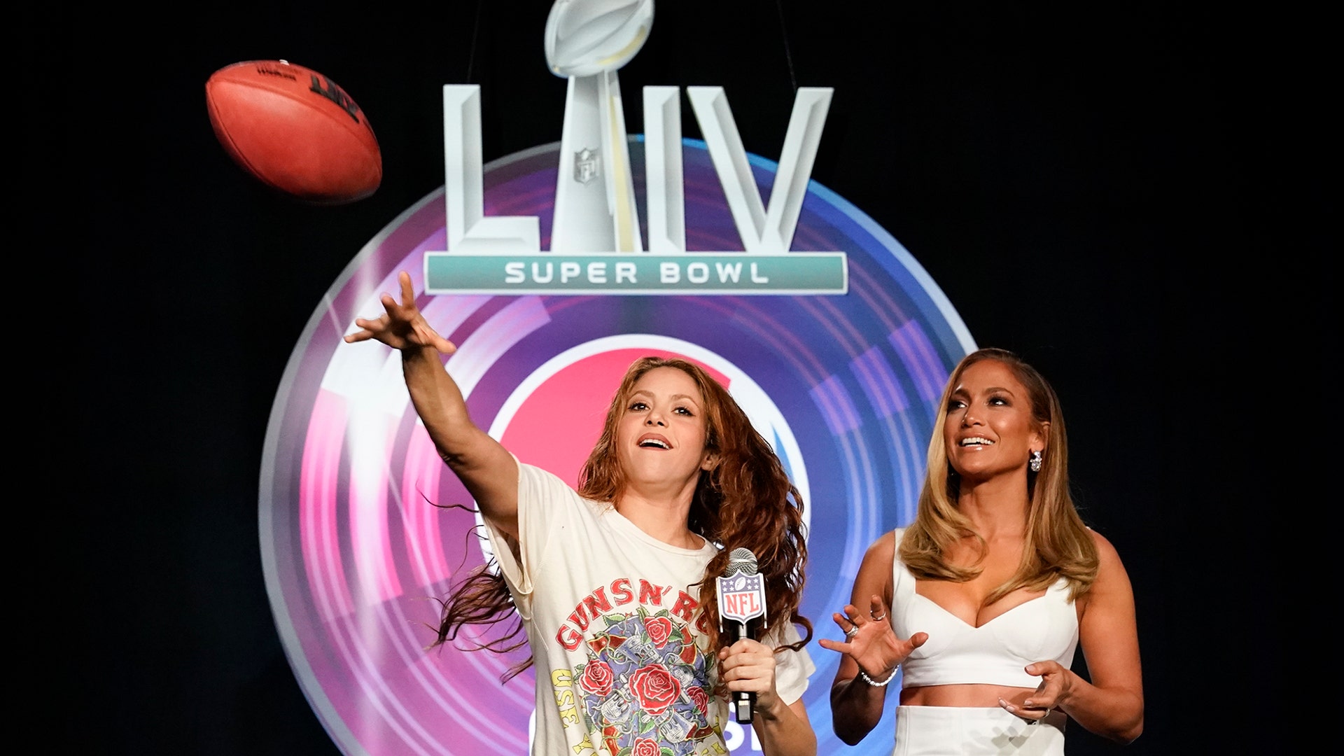 NFL Super Bowl 54 football game halftime performers  Shakira Jennifer Lopez throw a football during a news conference in Miami, Jan. 30, 2020.