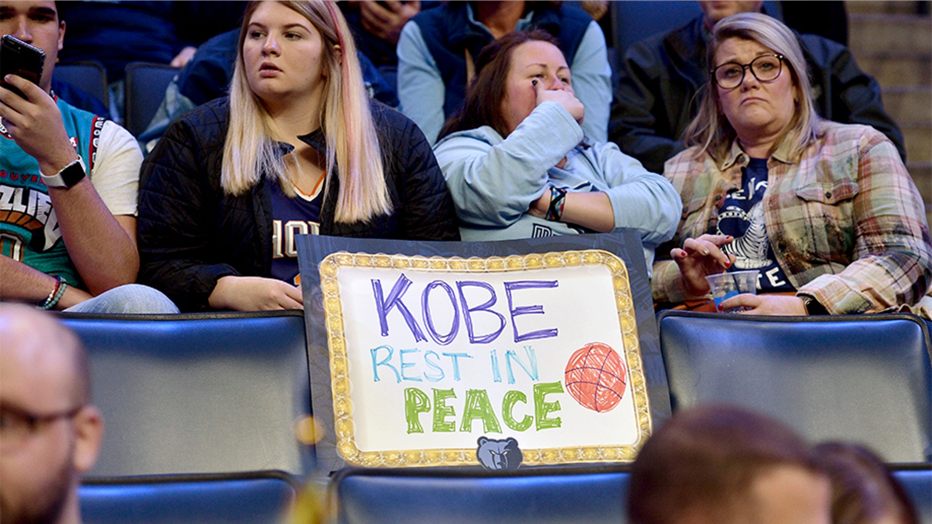 A sign reading "Kobe Rest In Peace" is displayed on an empty seat in the first half of a basketball game between the Phoenix Suns and the Memphis Grizzlies.